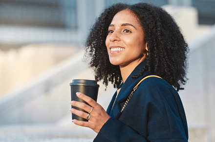 Coffee, thinking and city with a business black woman walking to walk during her morning commute. Idea, street and motivation with a female employee walking in an urban town during a summer day, a Photo by Peopleimages.com