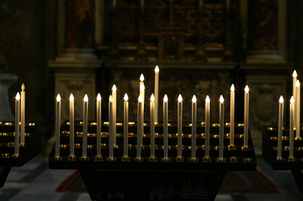 Burning electric candles lighting up a church interior, an Abstract Photo by Antonio Gravante Market