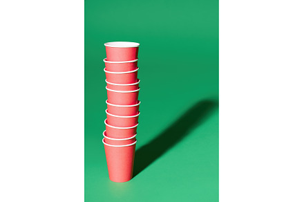 Stack of red paper cup on green, a Food & Drink Photo by Gladkov photography