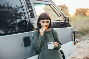 Cute girl snacks with coffee at camp containing woman, person, and coffee