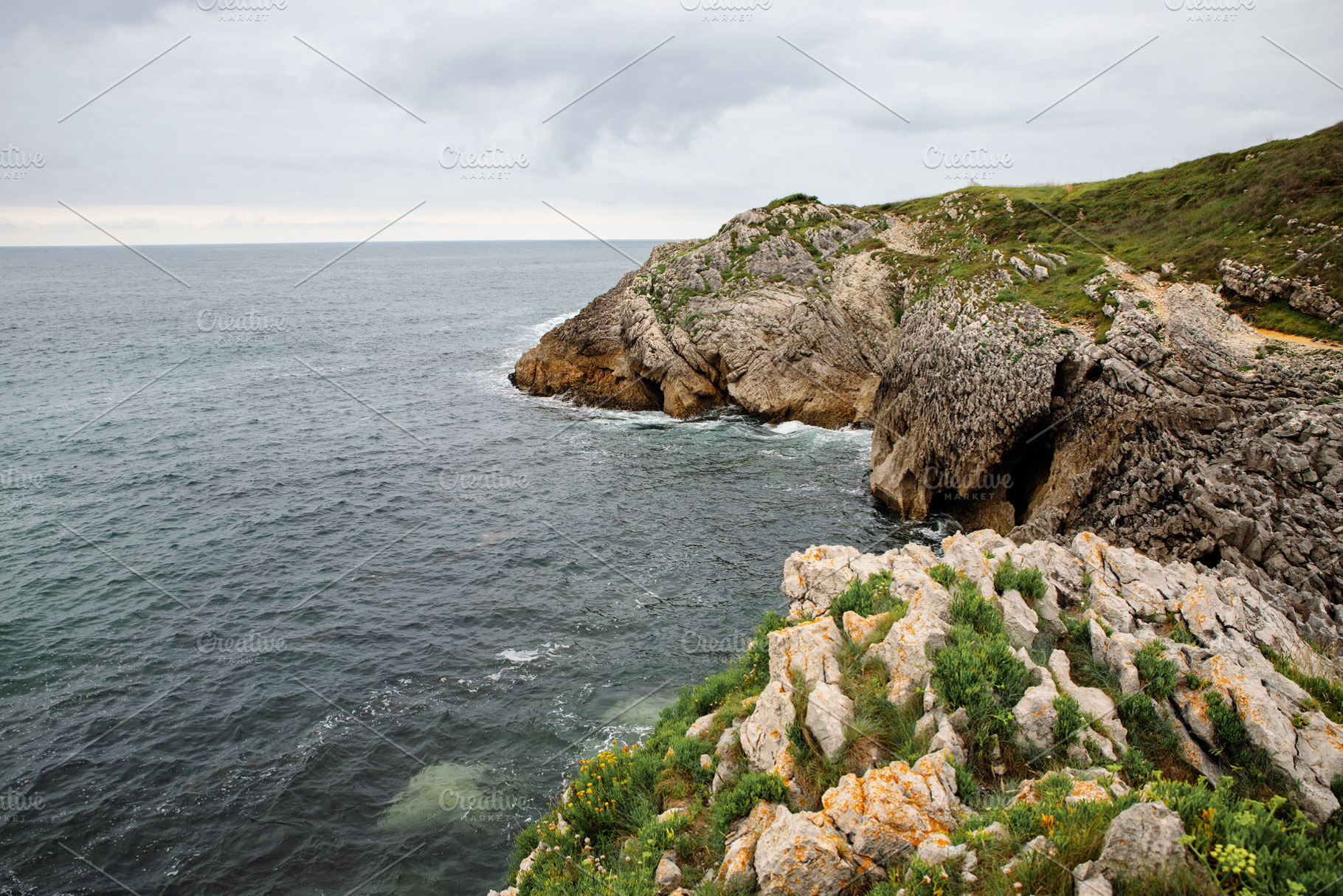 Rocky cliff overlooking the ocean wi, a Nature Photo by Perpis