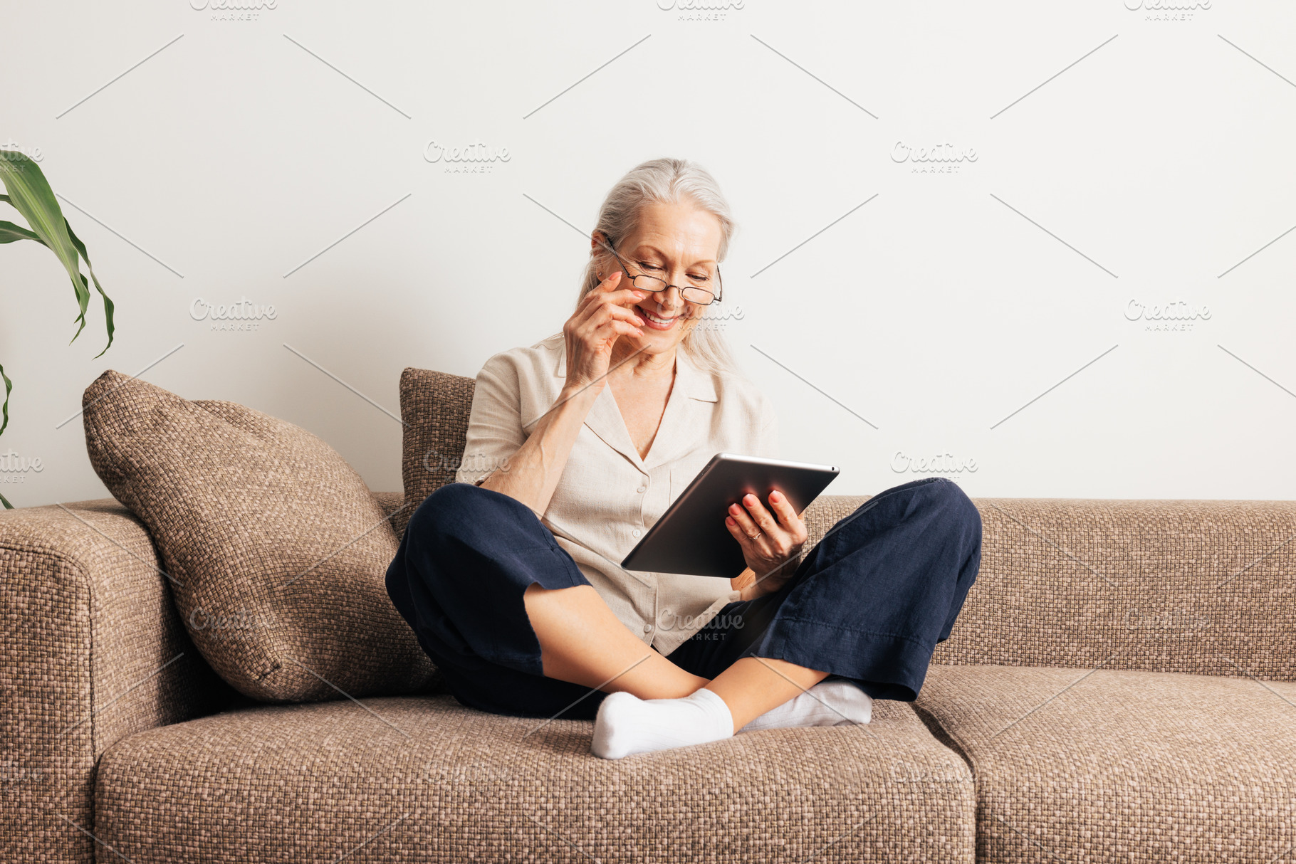 Smiling senior woman in eyeglasses, a Person Photo by Artem Varnitsin