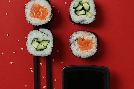 Concept of tasty food with maki on red background, a Food & Drink Photo by AtlasStudio