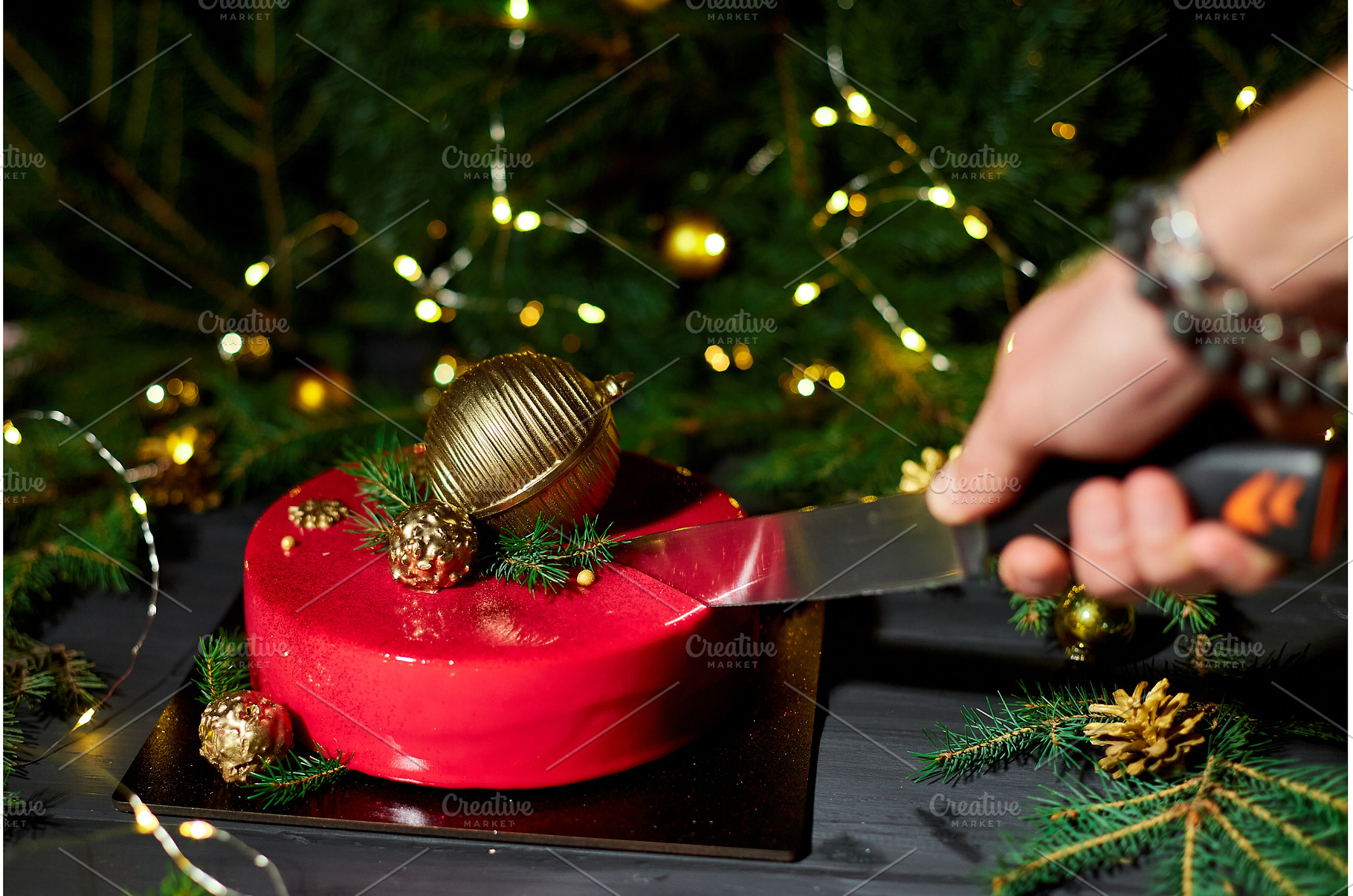 A Person Cuts a Festive Red Cake, a Holiday Photo by IlliaBondarPhotography