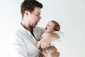 Stylish father holding and having fun with little baby son again, a Person Photo by Sonjachni