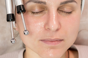 Microcurrent therapy face procedure woman device, a Person Photo by Photo Drive Studio