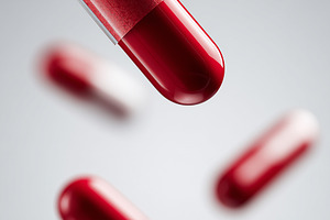 Red and transparent capsules float, a Health & Medical Photo by MistyDay