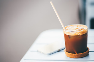 Iced espresso tonic on a cafe table, a Food & Drink Photo by SkyNext