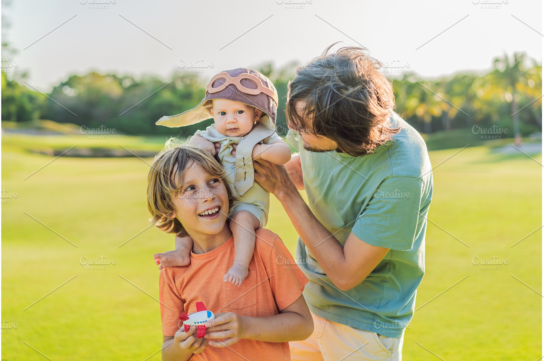 Father, son, and newborn on a meadow, a Person Photo by Elizaveta Galitskaya