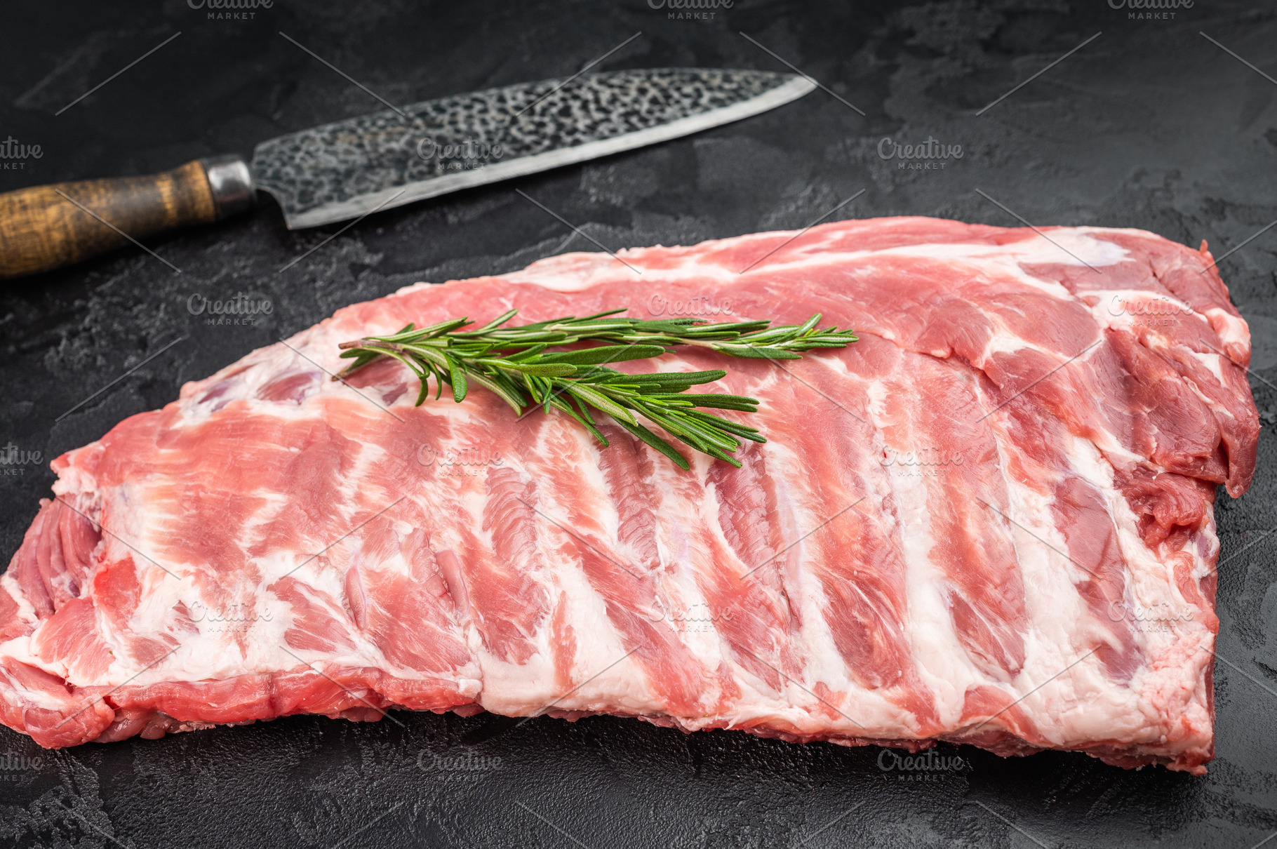 Raw pork spareribs slab with bone and butcher knife flat lay on, a Food & Drink Photo by composter-box@mail.ru