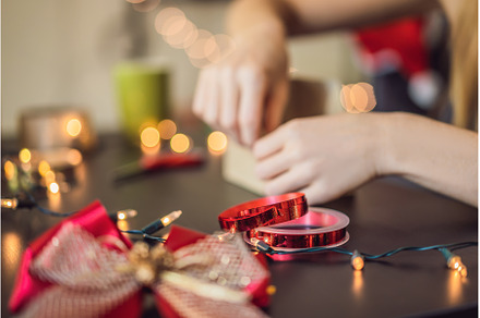 Young woman is packing presents, a Holiday Photo by Elizaveta Galitskaya