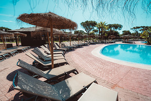 Empty poolside loungers and parasols, a Sports & Recreation Photo by SkyNext
