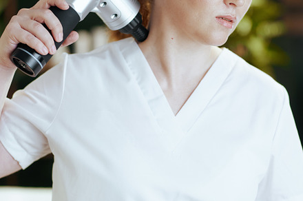 female medical massage therapist in massage cabinet, a Health & Medical Photo by Alliance Images