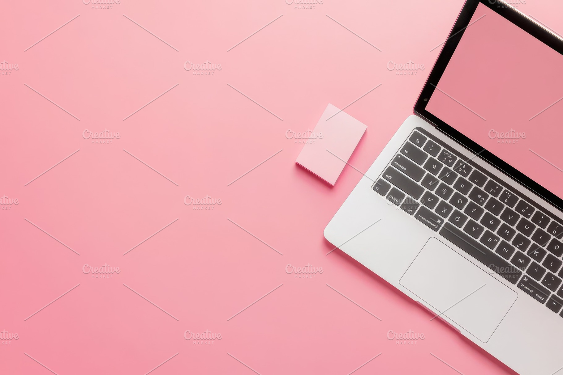 Laptop and pink notepad sit on pink, a Photo by Pavel_design