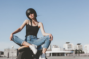 Girl sitting on motorcycle containing moto, caferacer, and bike, a Person Photo by Aliaksei Kaponia