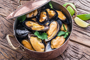 Mussels in copper pan on the wooden table., a Food & Drink Photo by Volff