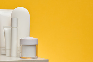 Set of white cosmetic packaging without brand on yellow backgrou, a Health & Medical Photo by ndanko