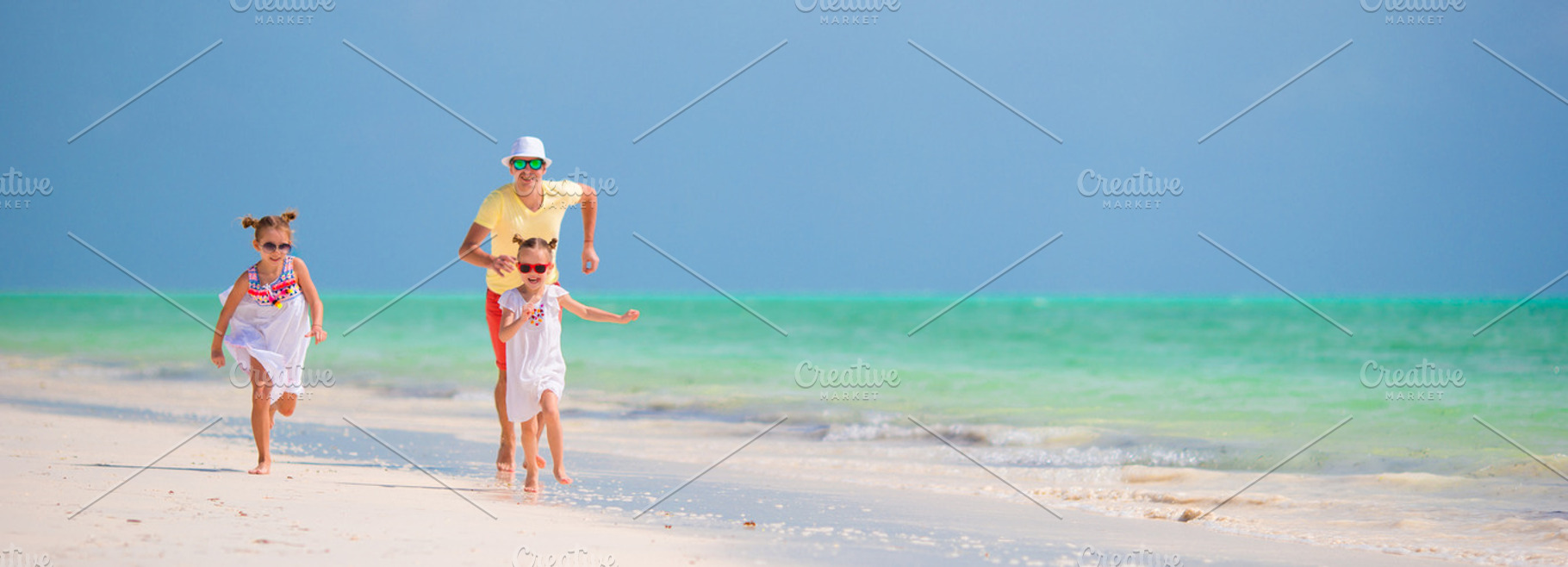 Happy family on beach vacation featuring adult, baby, and run, a Person Photo by travnikovstudio