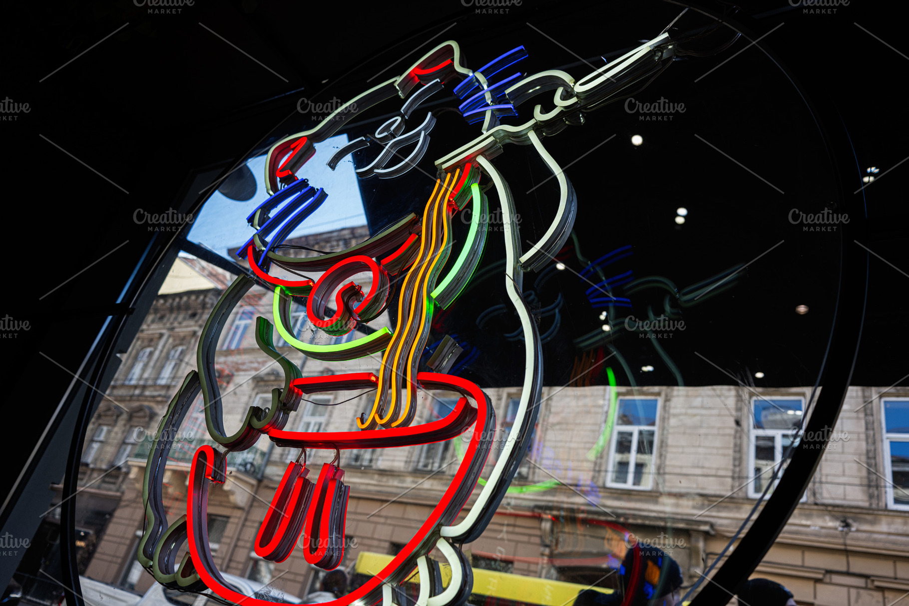 Colorful neon sign reflecting from a storefront window in urban surroundings, a Photo by AS photostudio