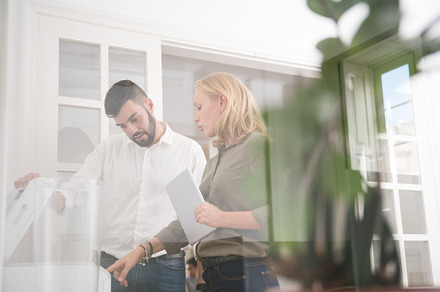Man and woman in an office using a p stock photo containing man and woman