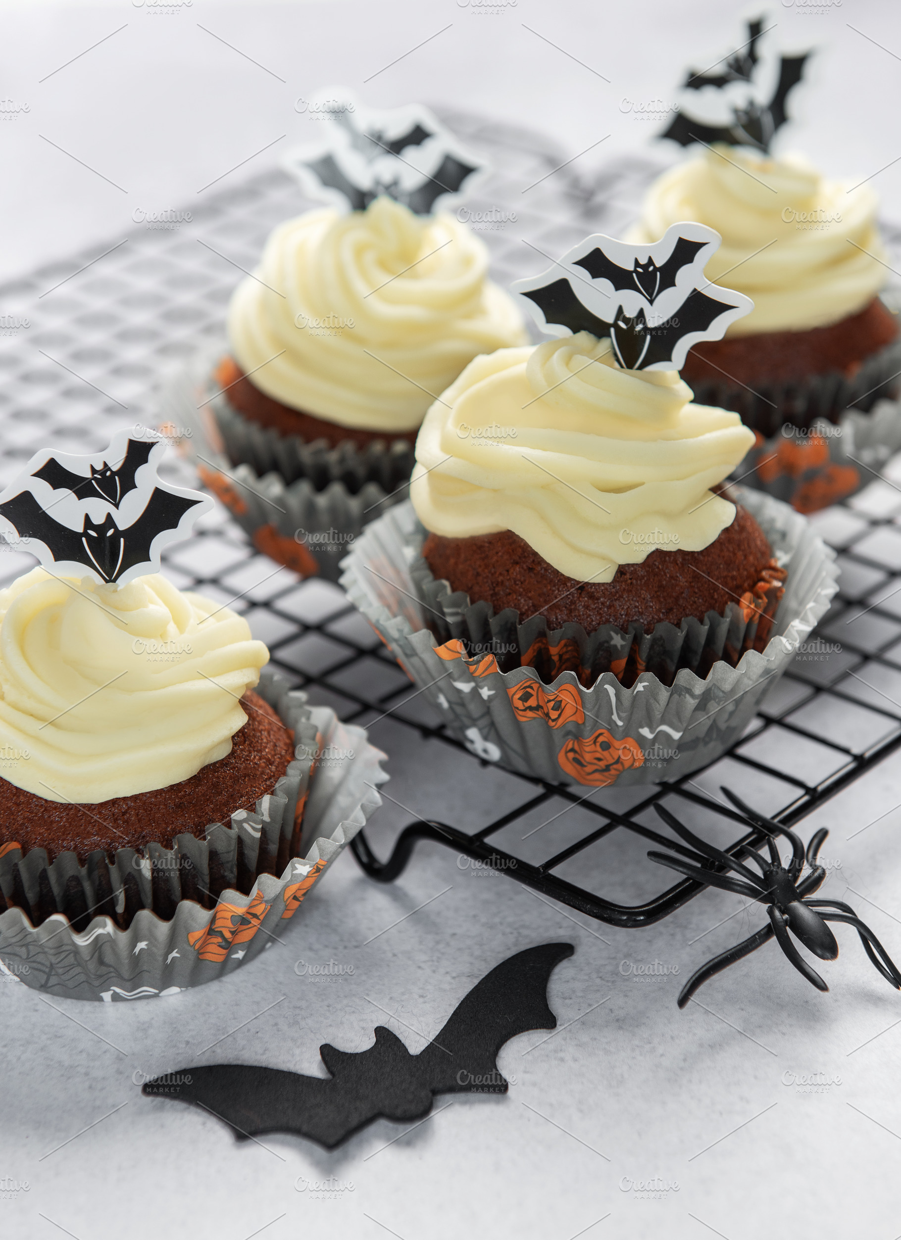 Halloween cupcakes with frosting and spooky bat decorations, a Food & Drink Photo by Olena Rudo