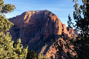 Utah landscape with red sandstone cliffs, pine trees, and a clear blue sky in n, a Nature Photo by AS photostudio