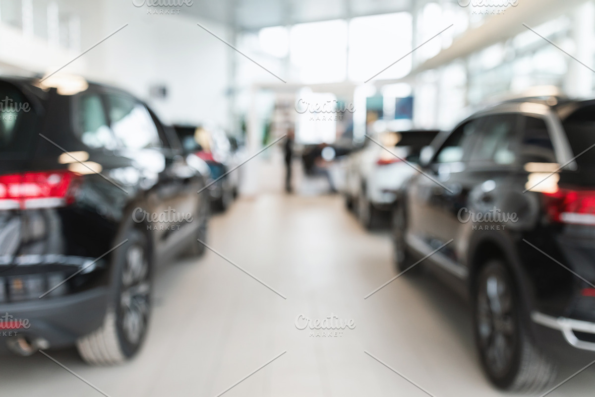 Vehicle purchase, rental, lease. Blurred view of automobile dealership store in, a Photo by Prostock-Studio (Photo 1 of 2)