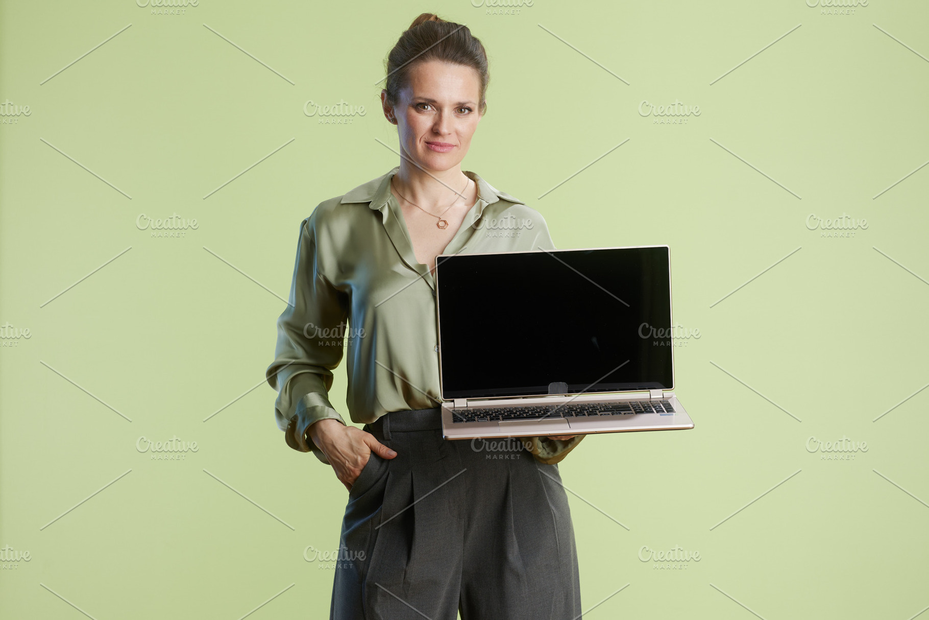 Confident businesswoman holding laptop, a Business Photo by Alliance Images