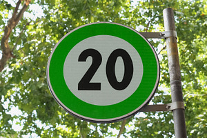 Green advisory speed limit sign, a Photo by WorldOfPhotos