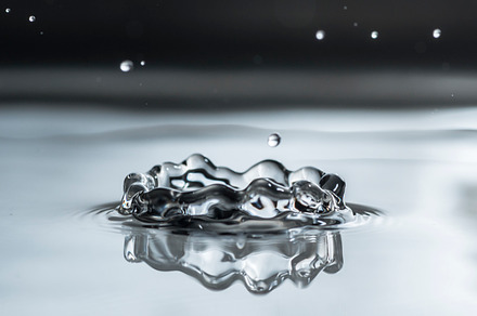 Water drop containing water, splash, and background