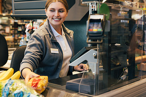 Smiling female cashier working, a Person Photo by Artem Varnitsin