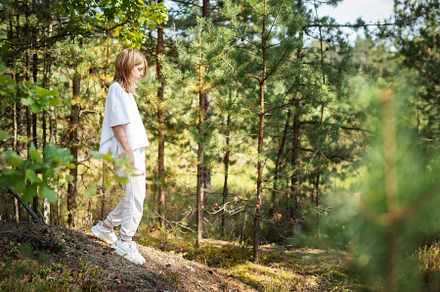 A child exploring a serene forest trail on a sunny day, surround, a Person Photo by Olena Rudo