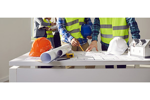 Professional builders discussing, a Business Photo by StudioRomantic