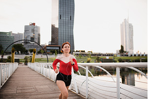 Front view of young woman runner, a Person Photo by HalfPoint