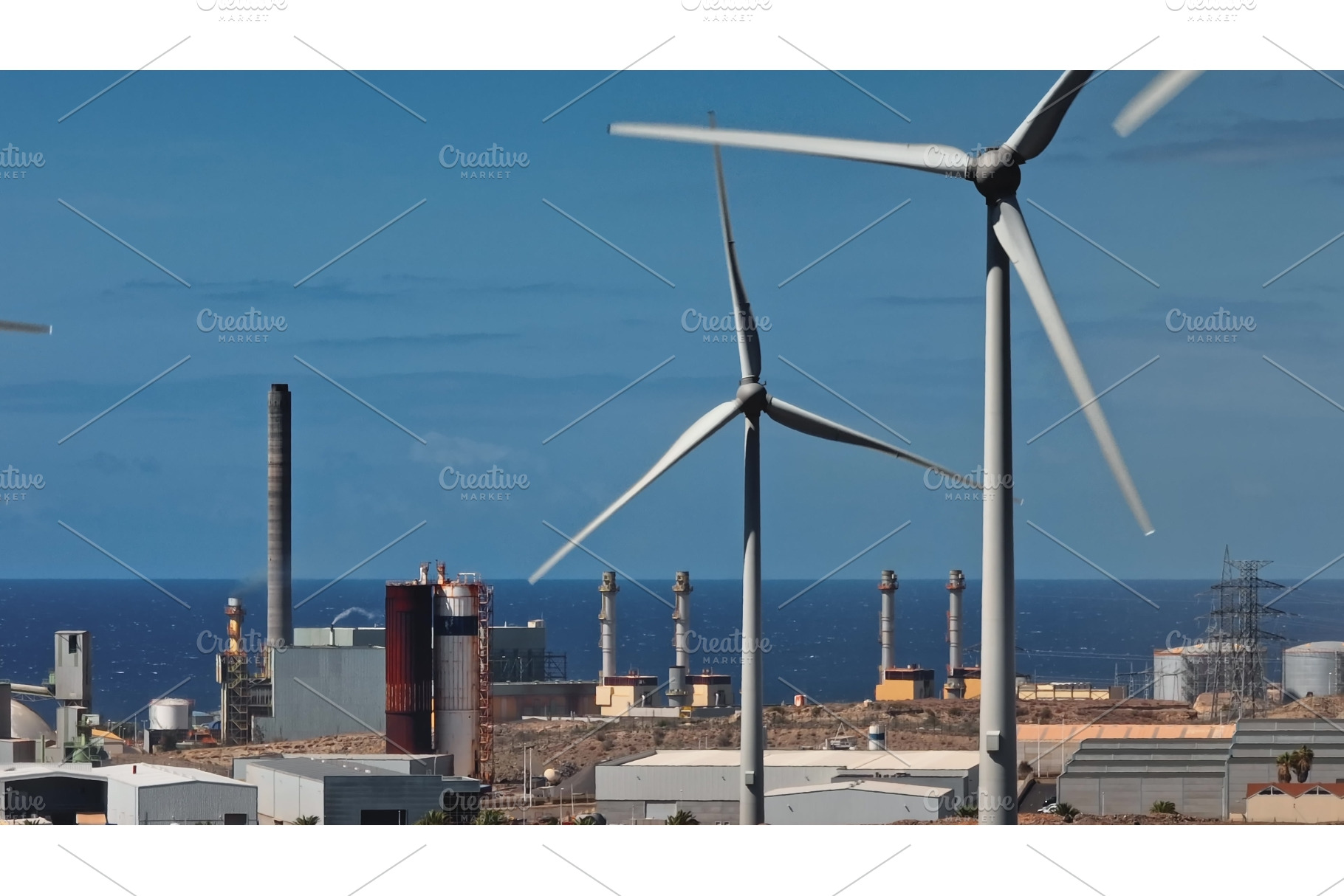 Wind turbines rotating near power, an Industrial Photo by Goinyk