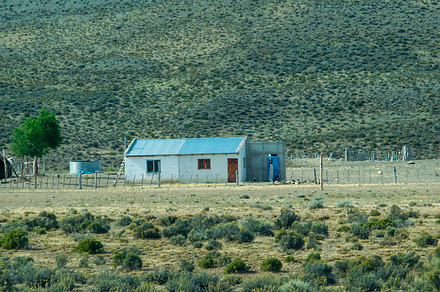 Rustic countryside house surrounded by the patagonian steppe lan, a Nature Photo by DanFLCreativo