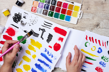 Set of watercolor paints, brushes and paper with different strok, a School & Education Photo by ndanko