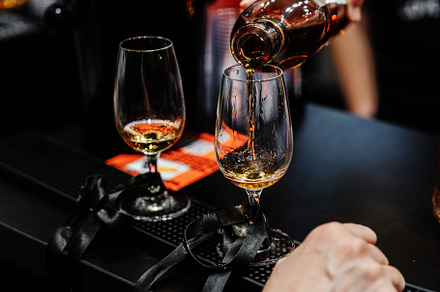 Bartender pours whiskey for tasting.