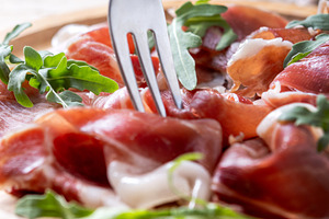 Fork picking sliced serrano ham, a Food & Drink Photo by etorres69