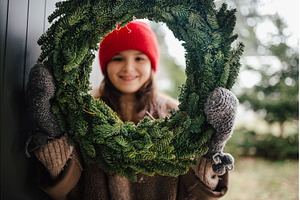 Girl holding a handmade Christmas, a Holiday Photo by HalfPoint