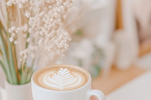 A woman holding cozy mug with latte, a Photo by Dvoevnore photos