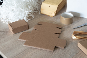 Cardboard packaging blanks and packing filler on work table, an Industrial Photo by MDBildes