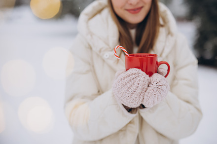 Cute happy woman holding hot coffee, a Holiday Photo by Cherkas Photography