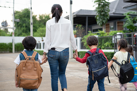 Group of preschool student and teacher holding hands and walking, a Person Photo by Ministocker
