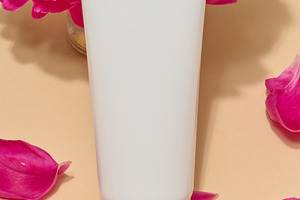 Close-up of white cosmetic tube without label surrounded by brig, a Beauty & Fashion Photo by ndanko