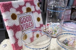 Decorative drinkware set with floral motif and good vibes sign i, a Photo by AS photostudio