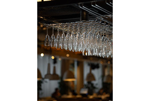 Row of clean empty glasses in bar, a Food & Drink Photo by Fascinadora