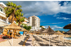 Straw umbrellas on a beach in containing beach, umbrella, and sea, a Nature Photo by Leonid Andronov