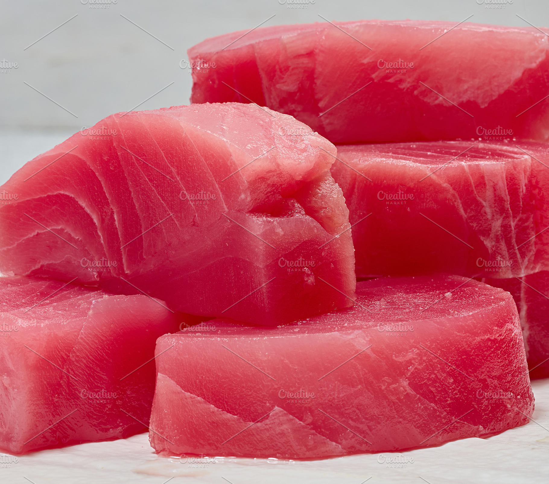 A stack of raw tuna pieces on a white board, a Food & Drink Photo by ndanko