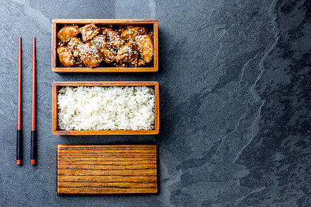 Japanese food chicken teriyaki with rice in wooden bento lunch box slate, a Food & Drink Photo by LARISA BLINOVA